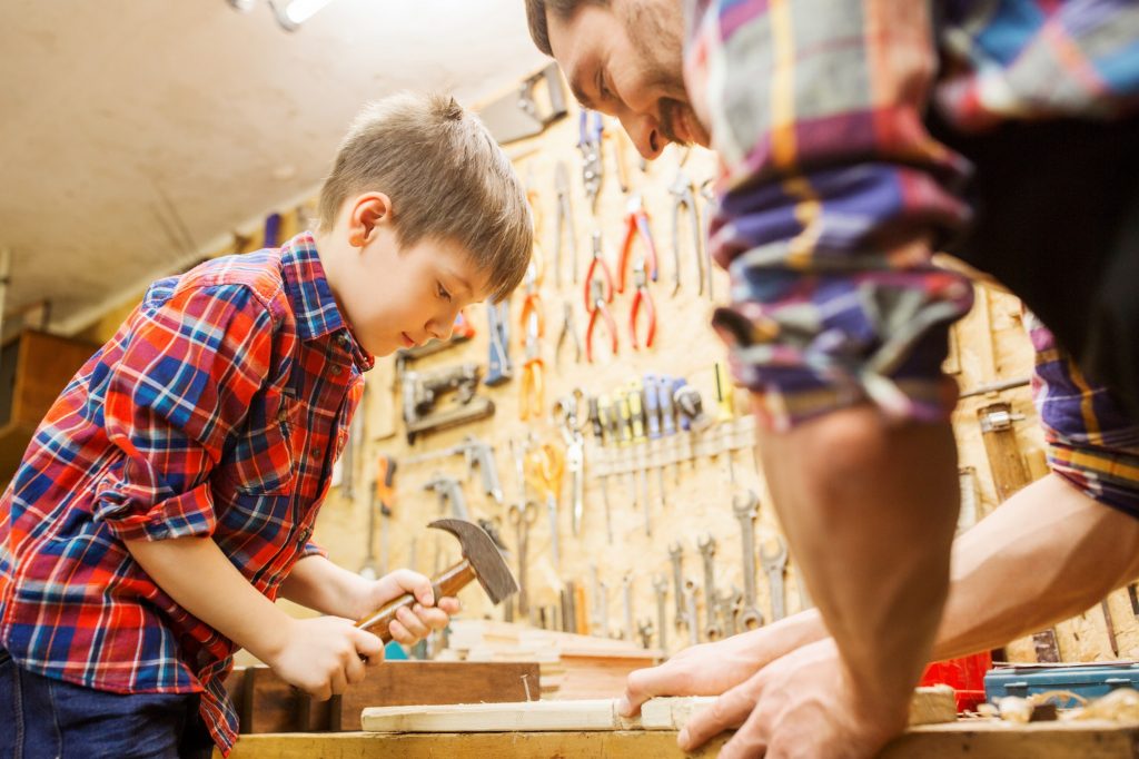 Caring for the seventh generation by caring for the next one (father teaching son craft skills).